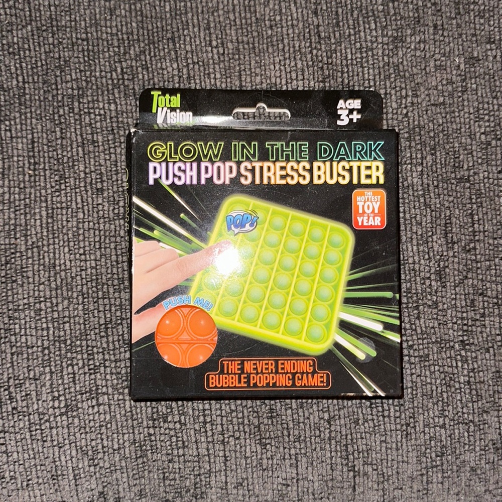 NWT orange glow in the dark push pop stress buster. Age 3+